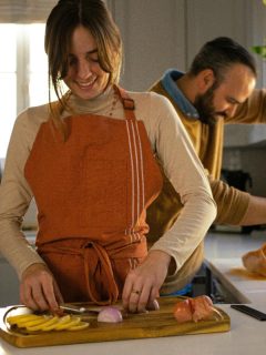 a couple in the kitchen preparing food for a holiday meal